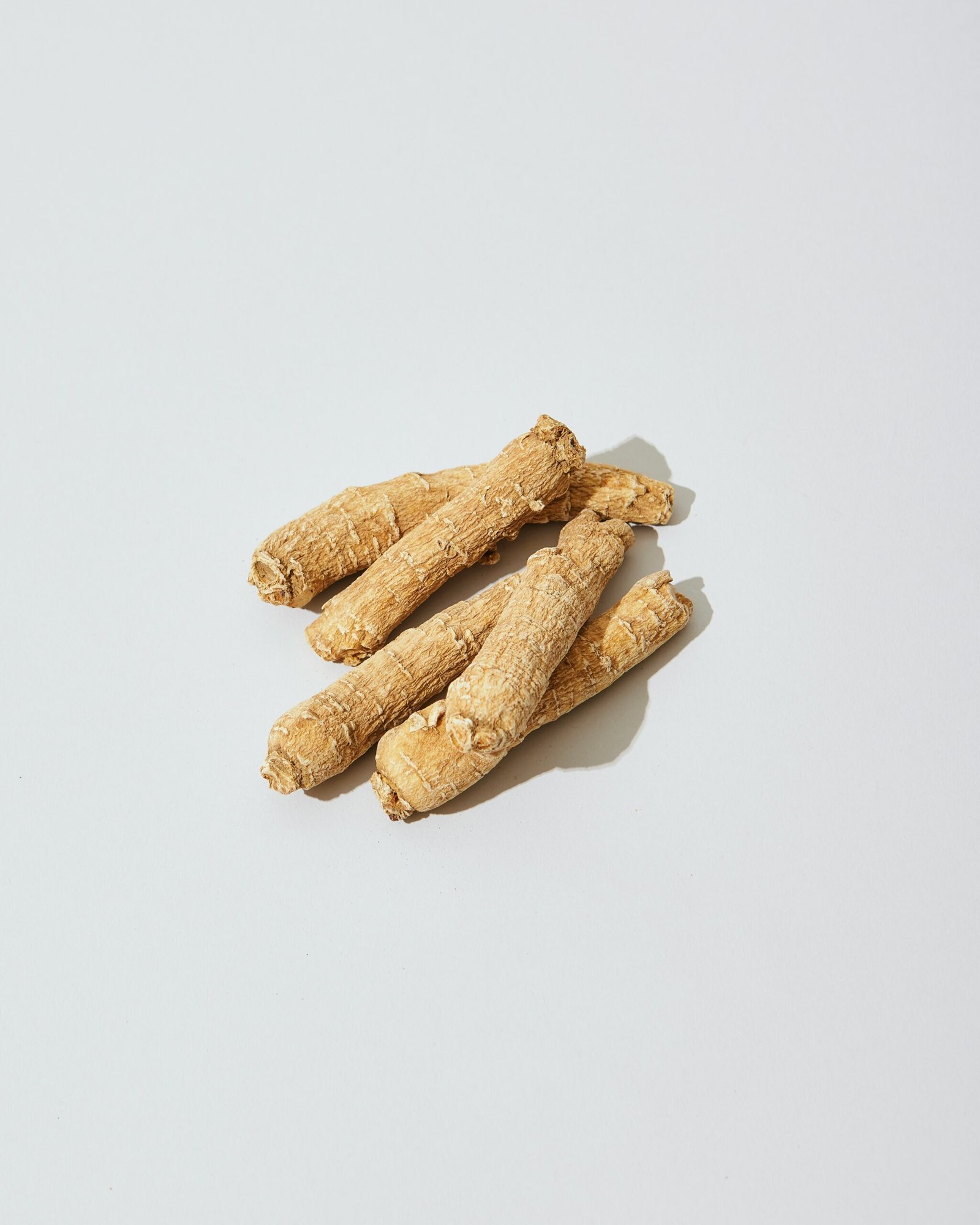 three pieces of ginger on a white surface